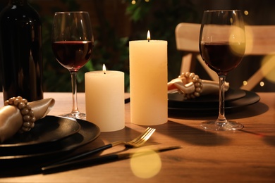 Beautiful table setting with glasses of wine and candles. Romantic dinner for Valentine's day