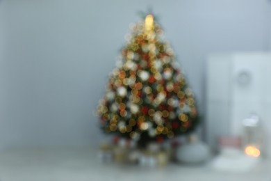 Blurred view of beautifully decorated Christmas tree in room