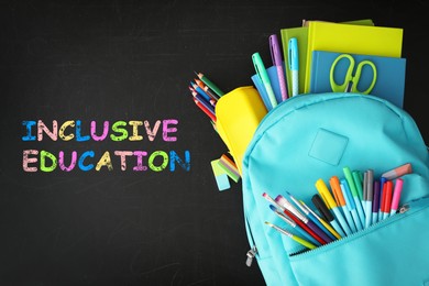 Image of Turquoise backpack with different stationery and phrase INCLUSIVE EDUCATION on blackboard, top view