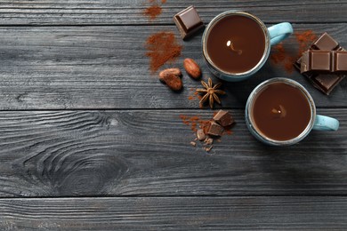 Photo of Flat lay composition with yummy hot chocolate on black wooden table. Space for text