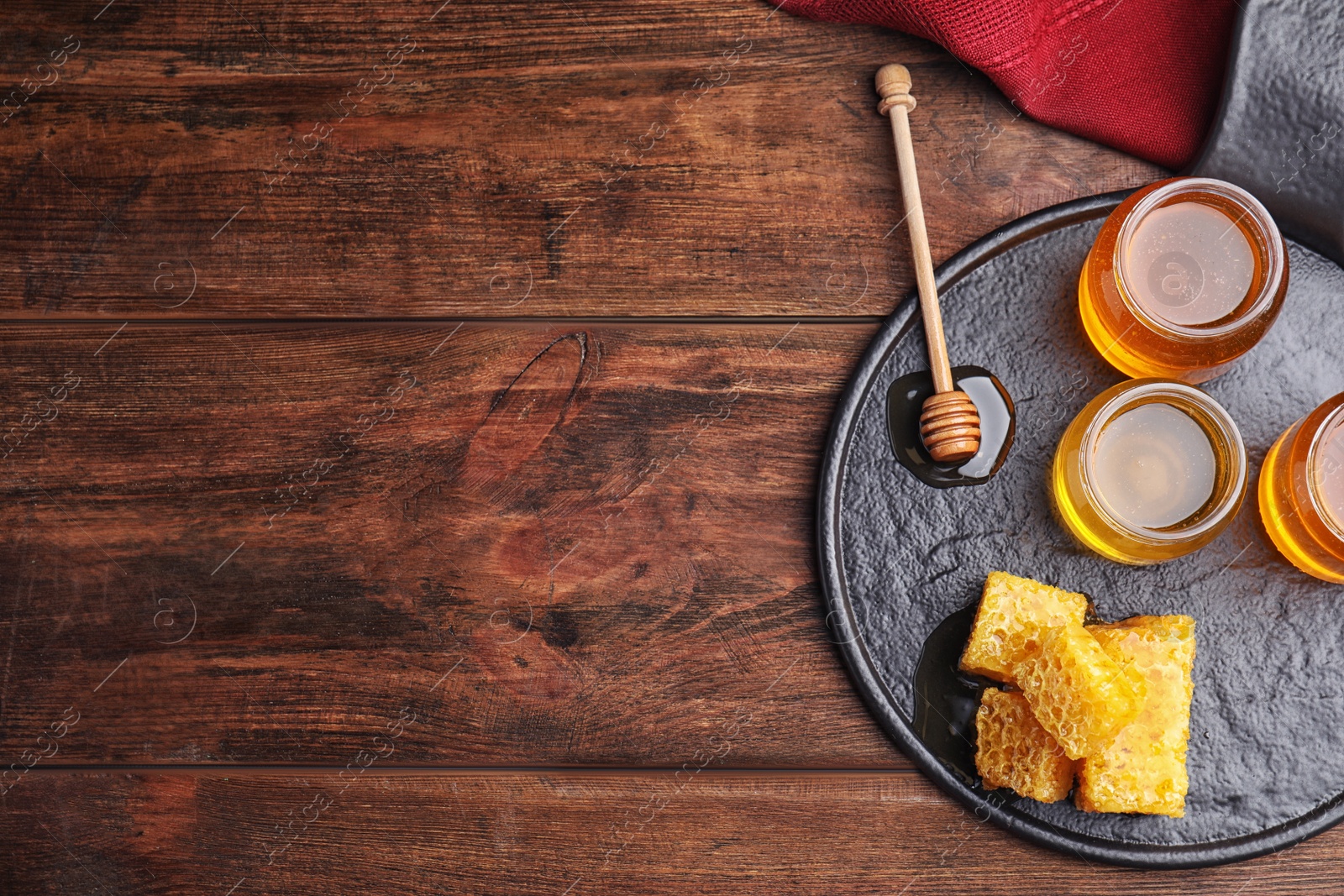 Photo of Flat lay composition with delicious honey on wooden table. Space for text