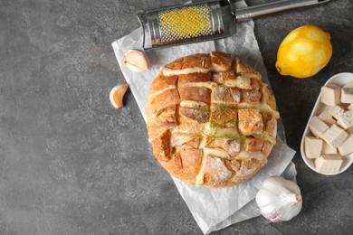 Photo of Freshly baked bread with tofu cheese served on grey table, flat lay. Space for text