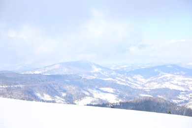 Photo of Picturesque view of snowy hills at mountain resort