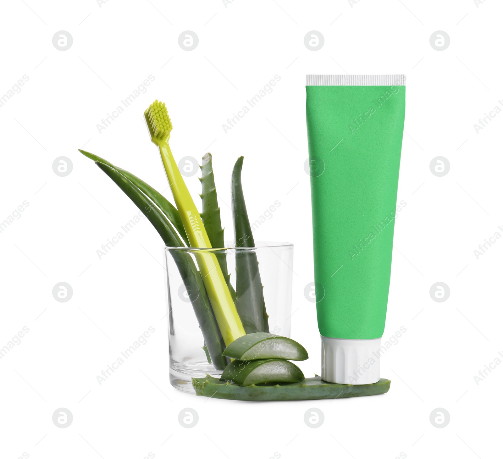 Photo of Tube of toothpaste, brush and aloe vera leaves on white background