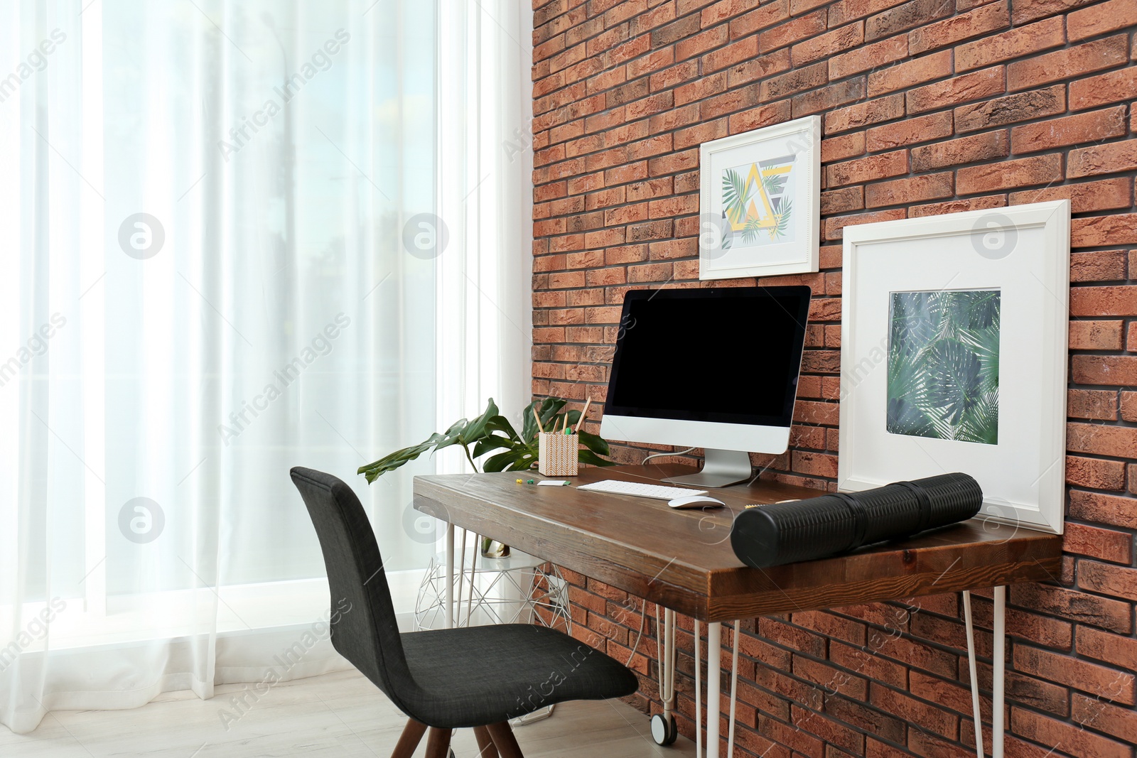 Photo of Interior of stylish workplace with modern computer at home
