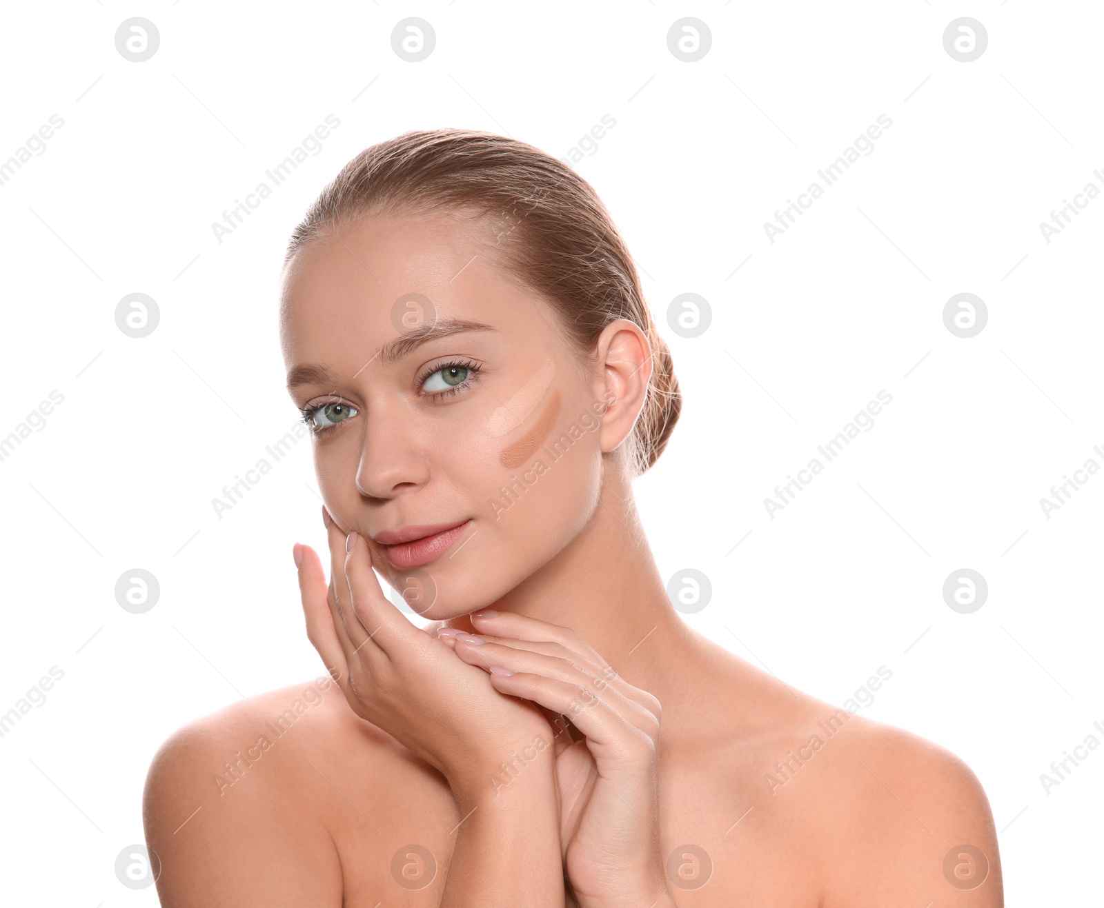 Photo of Young woman with different shades of skin foundation on her face against white background