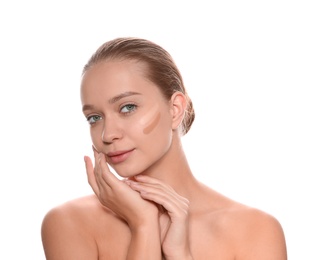 Young woman with different shades of skin foundation on her face against white background