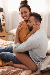 Photo of Lovely couple enjoying each other on bed at home