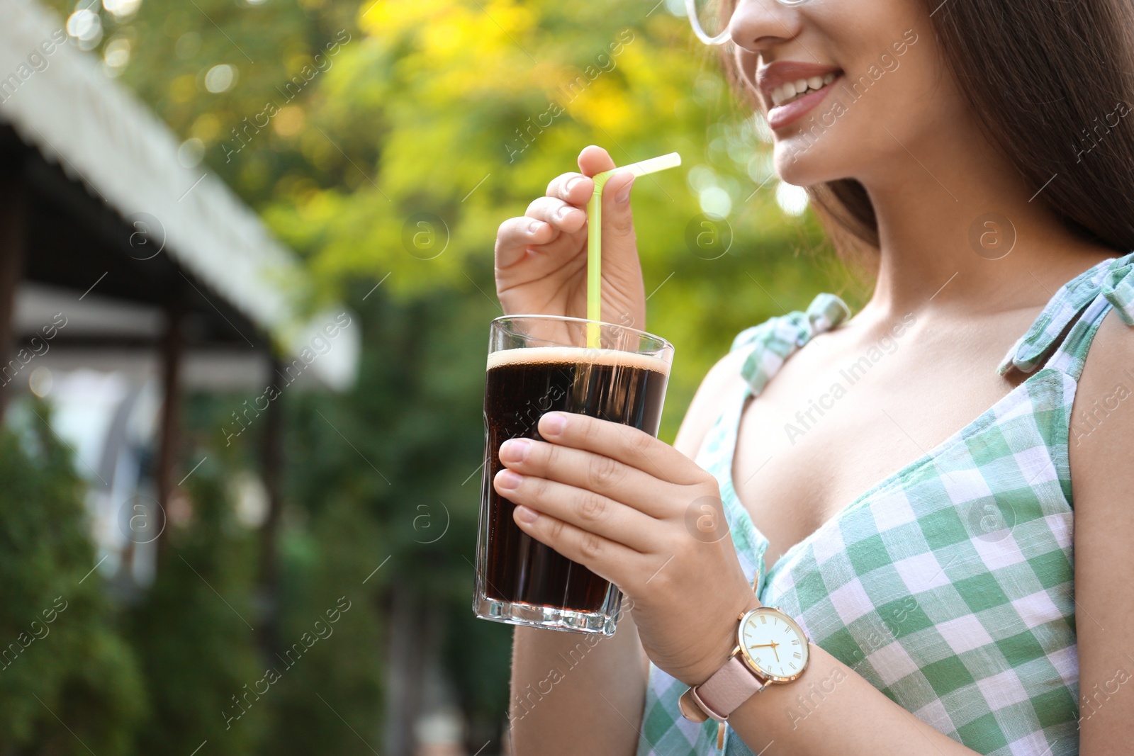 Photo of Young woman with cold kvass outdoors, closeup. Traditional Russian summer drink