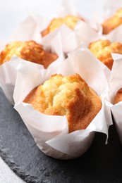 Photo of Delicious sweet muffins on grey table, closeup