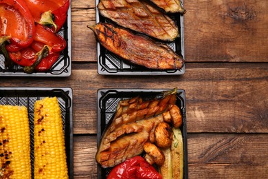 Photo of Plastic containers with different grilled meal on wooden table, flat lay. Food delivery service