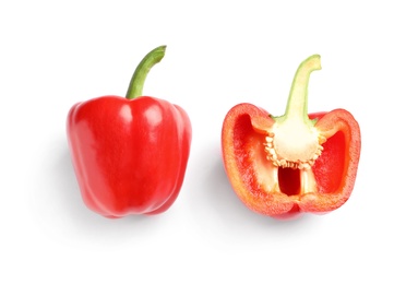 Photo of Cut and whole ripe red bell peppers on white background, top view