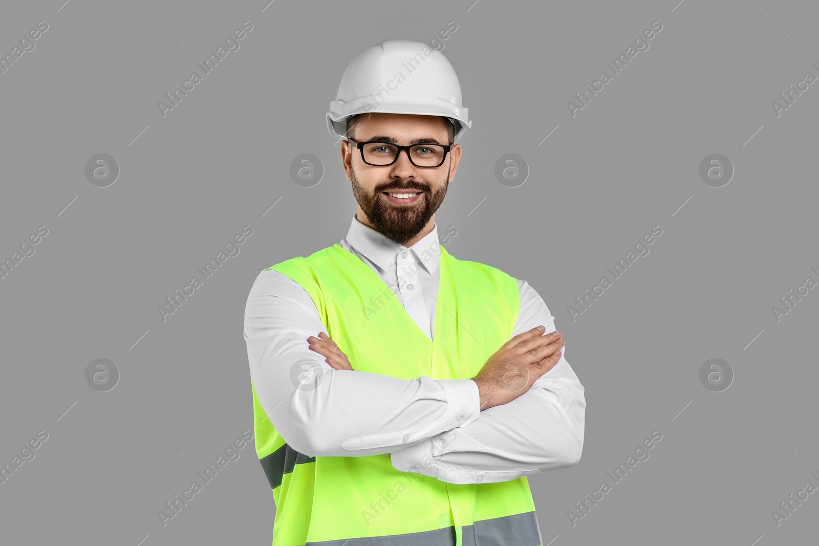 Photo of Engineer in hard hat on grey background