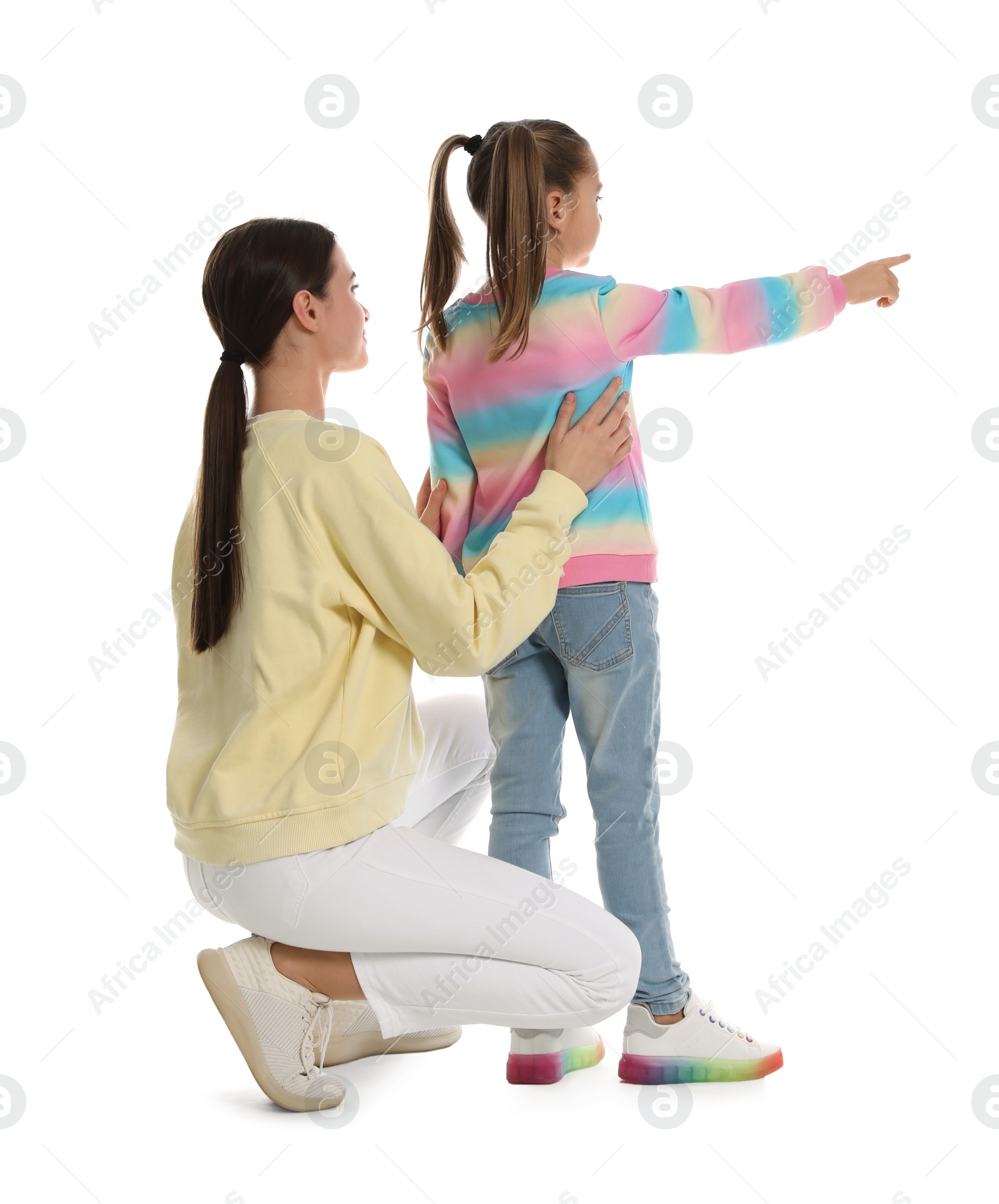 Photo of Little girl with her mother on white background