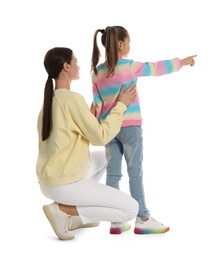 Little girl with her mother on white background