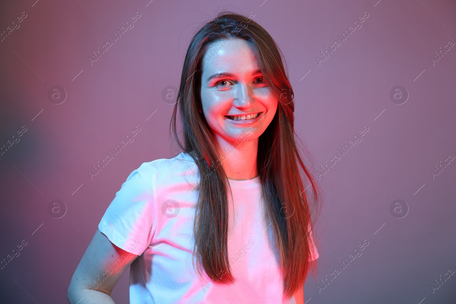 Photo of Portrait of beautiful woman in neon lights on color background