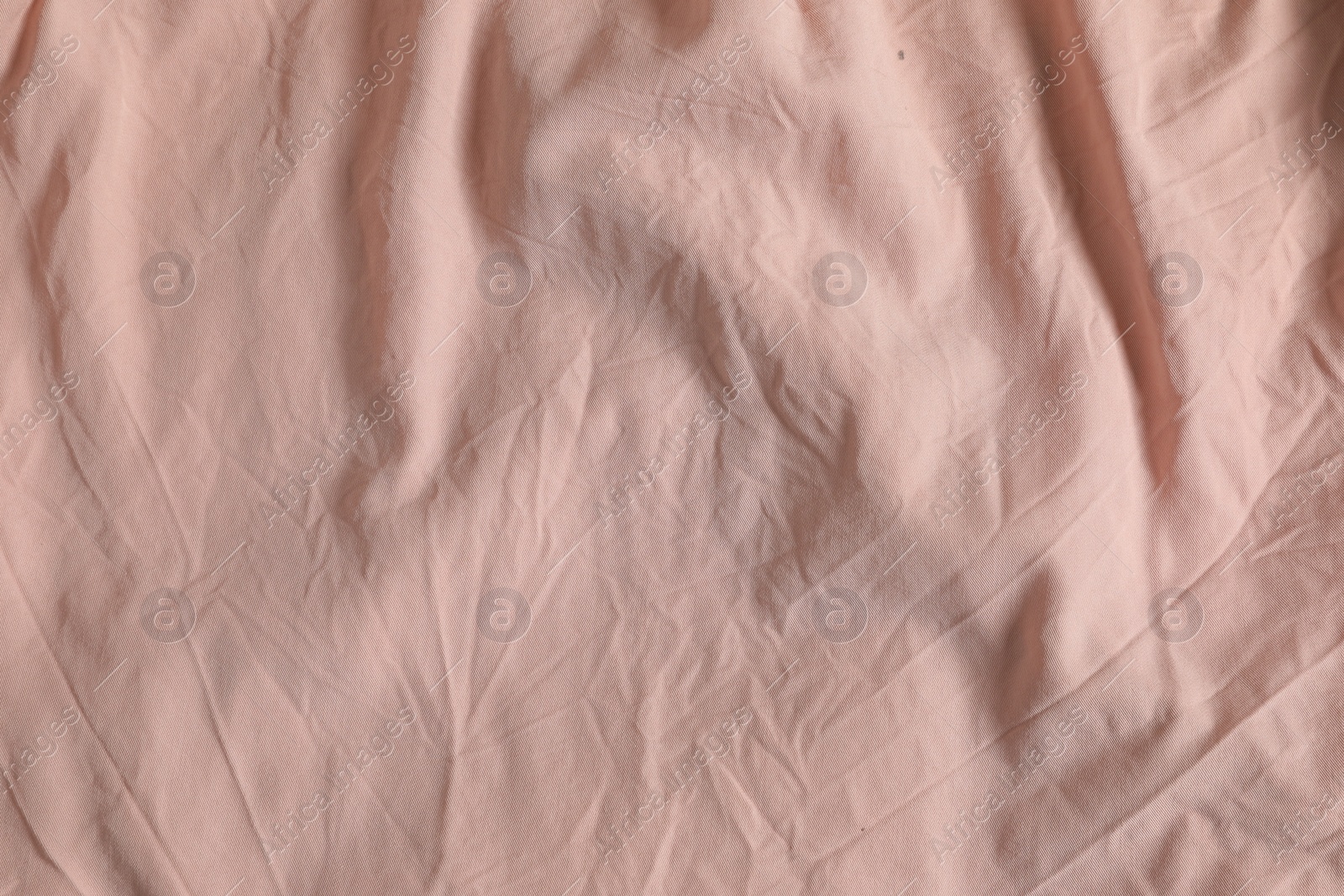 Photo of Crumpled pink fabric as background, top view