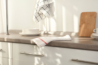 Photo of White towel on wooden table in kitchen