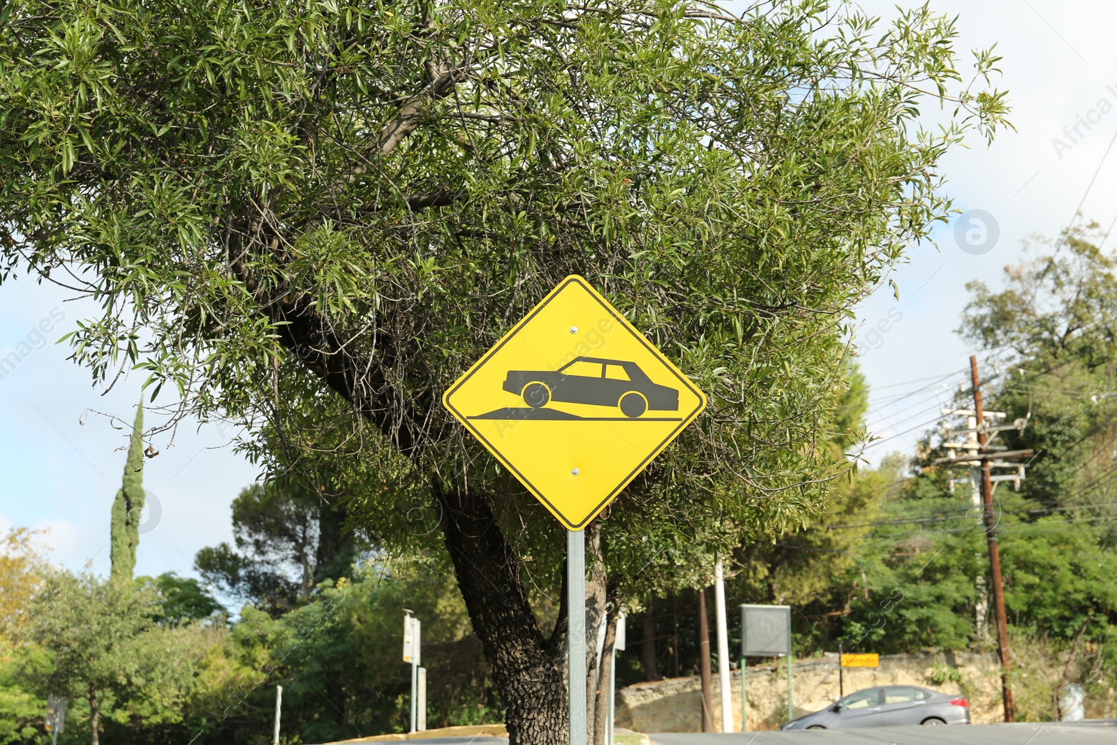 Photo of Speed bump road sign on city street