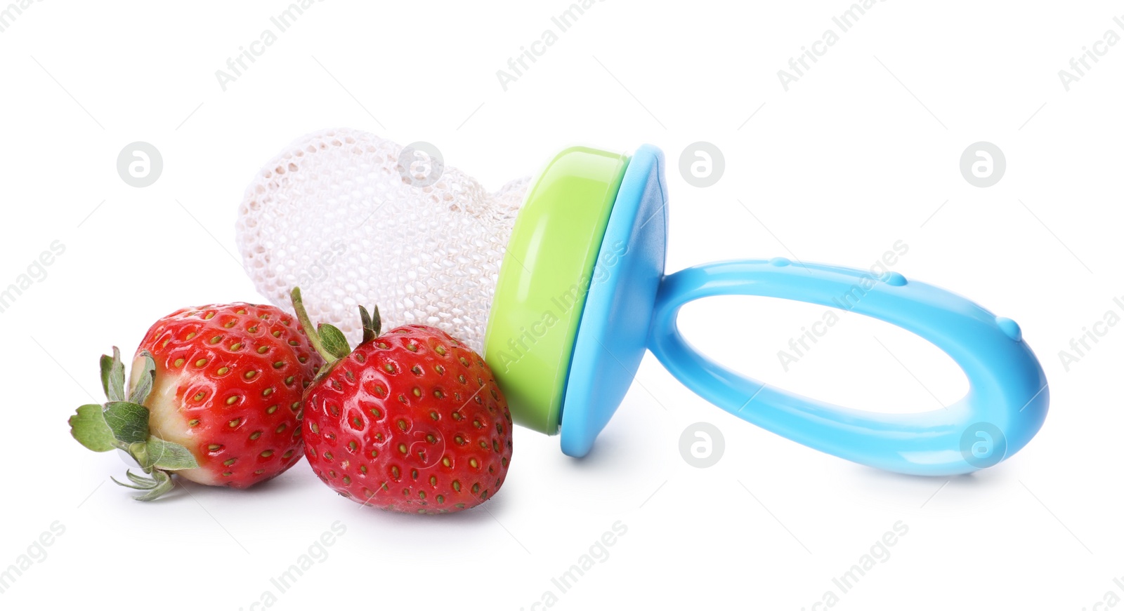 Photo of Empty nibbler and strawberries on white background. Baby feeder