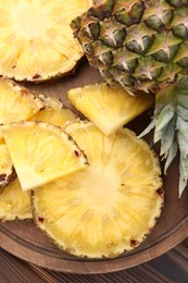 Pieces of tasty ripe pineapple on table, top view