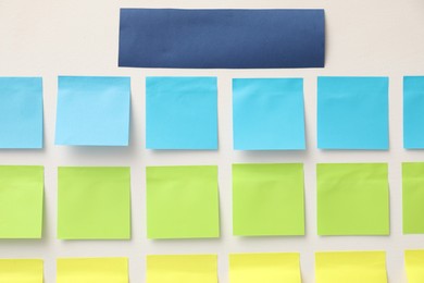 Photo of Blank colorful paper notes on white board, closeup