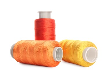 Photo of Different colorful sewing threads on white background