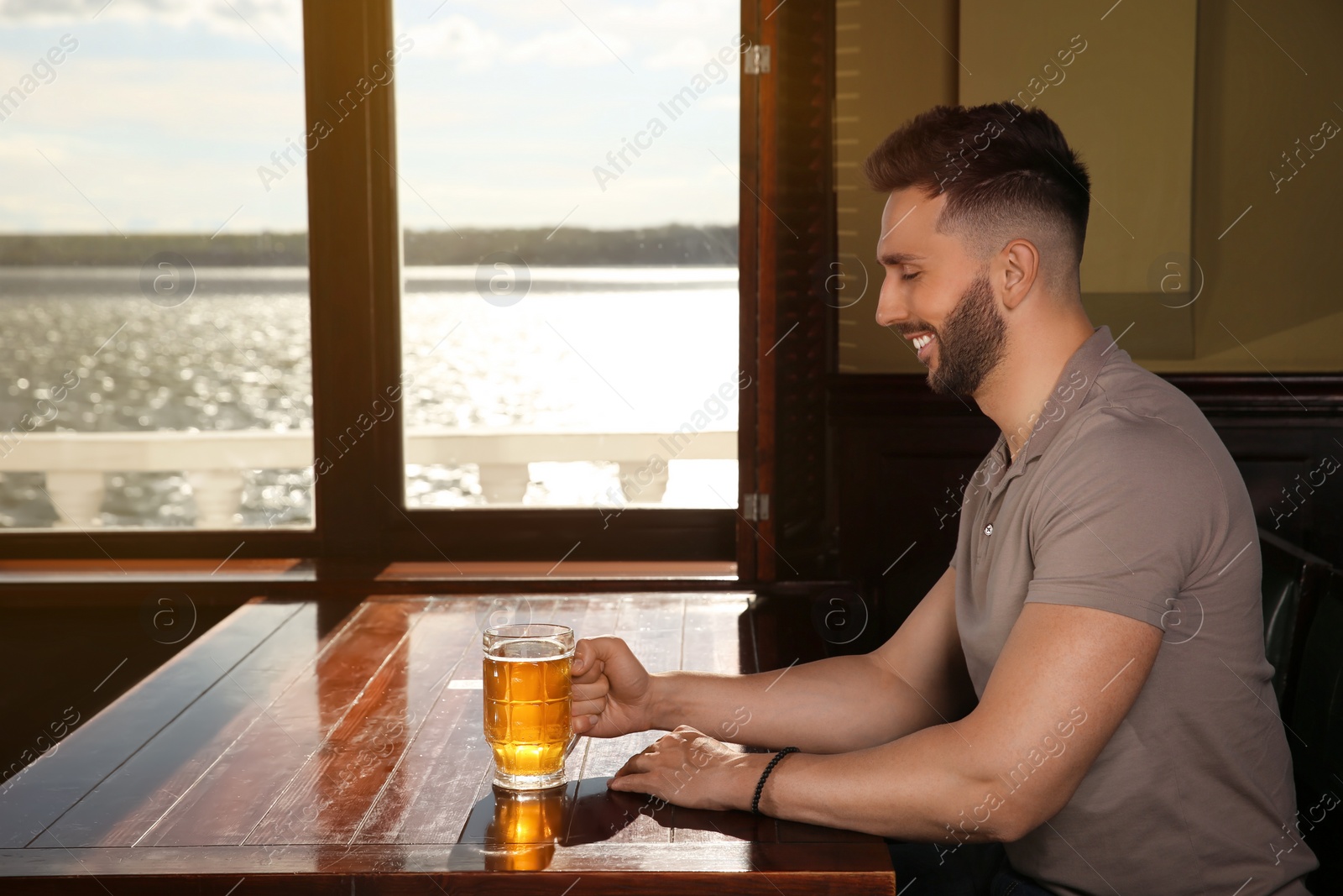 Photo of Man with glass of tasty beer in pub