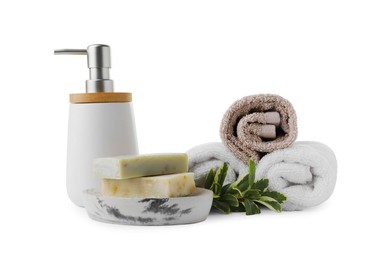 Soap bars, dispenser and terry towels on white background