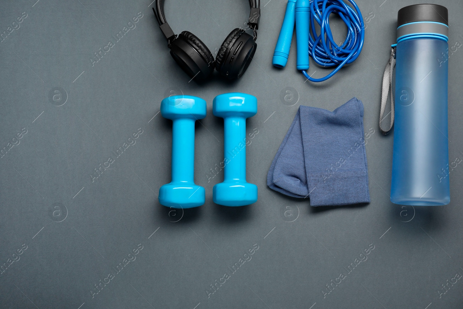 Photo of Sports equipment, socks and headphones on grey background, flat lay. Space for text