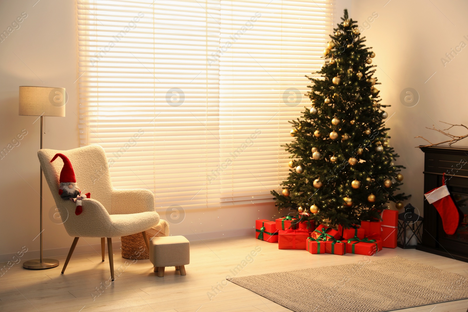 Photo of Beautifully wrapped gift boxes under Christmas tree in living room