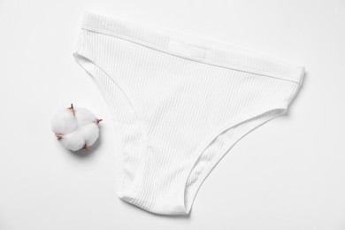 Photo of Stylish women's underwear and cotton flower on white background, flat lay