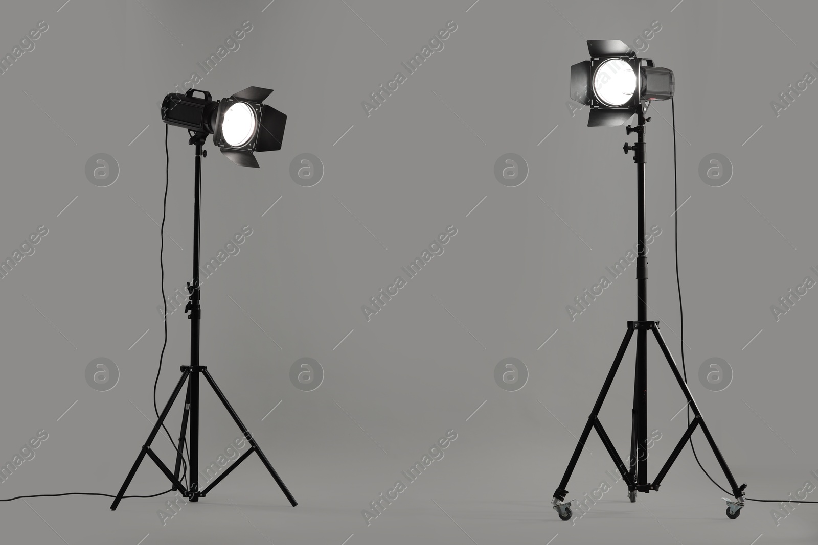 Photo of Grey photo background and professional lighting equipment in studio