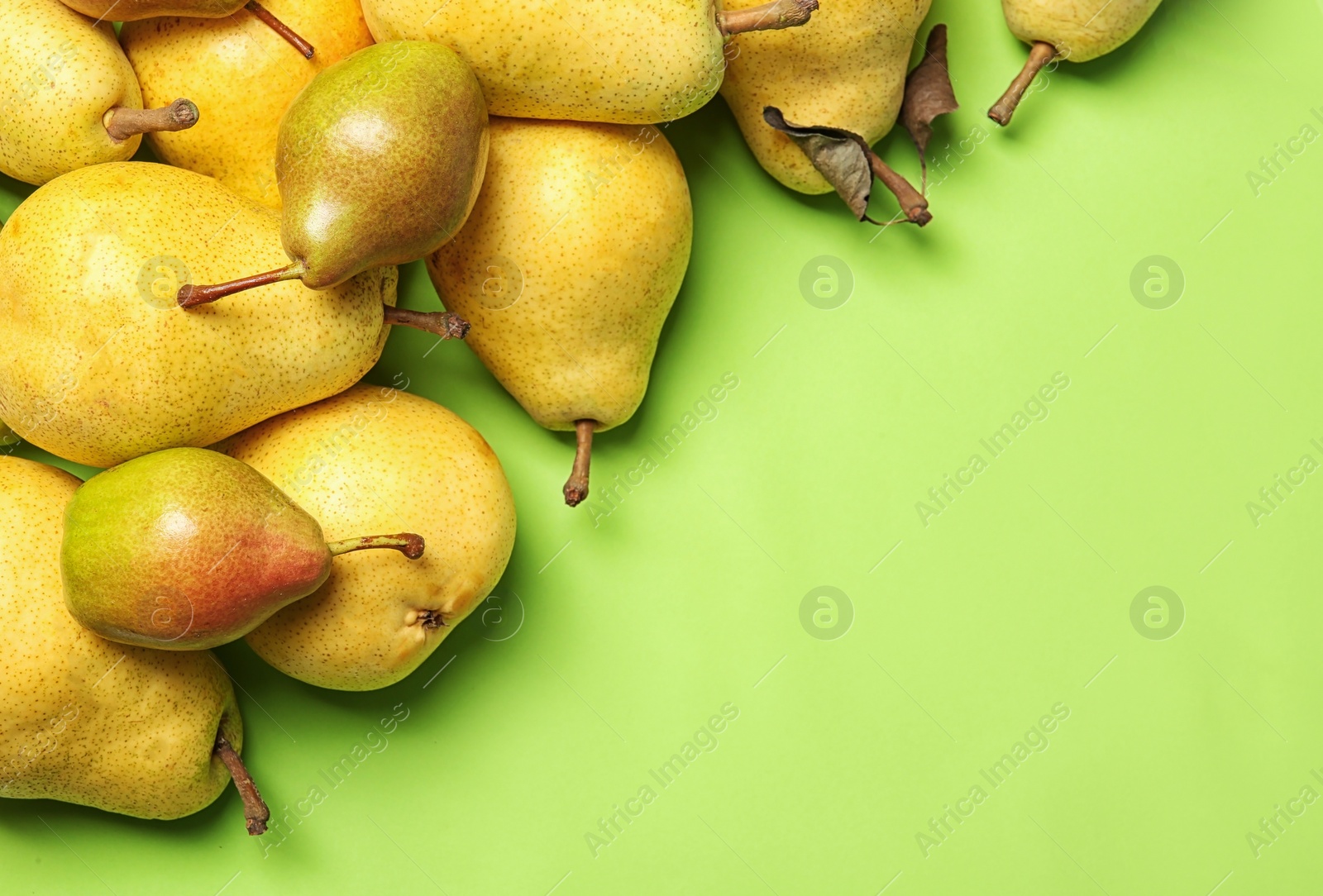 Photo of Flat lay composition with fresh ripe pears and space for text on color background