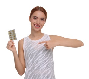 Photo of Happy young woman with pills on white background. Weight loss