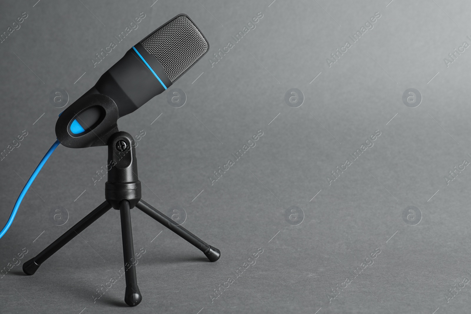 Photo of Professional condenser microphone on grey background, space for text. Musical equipment