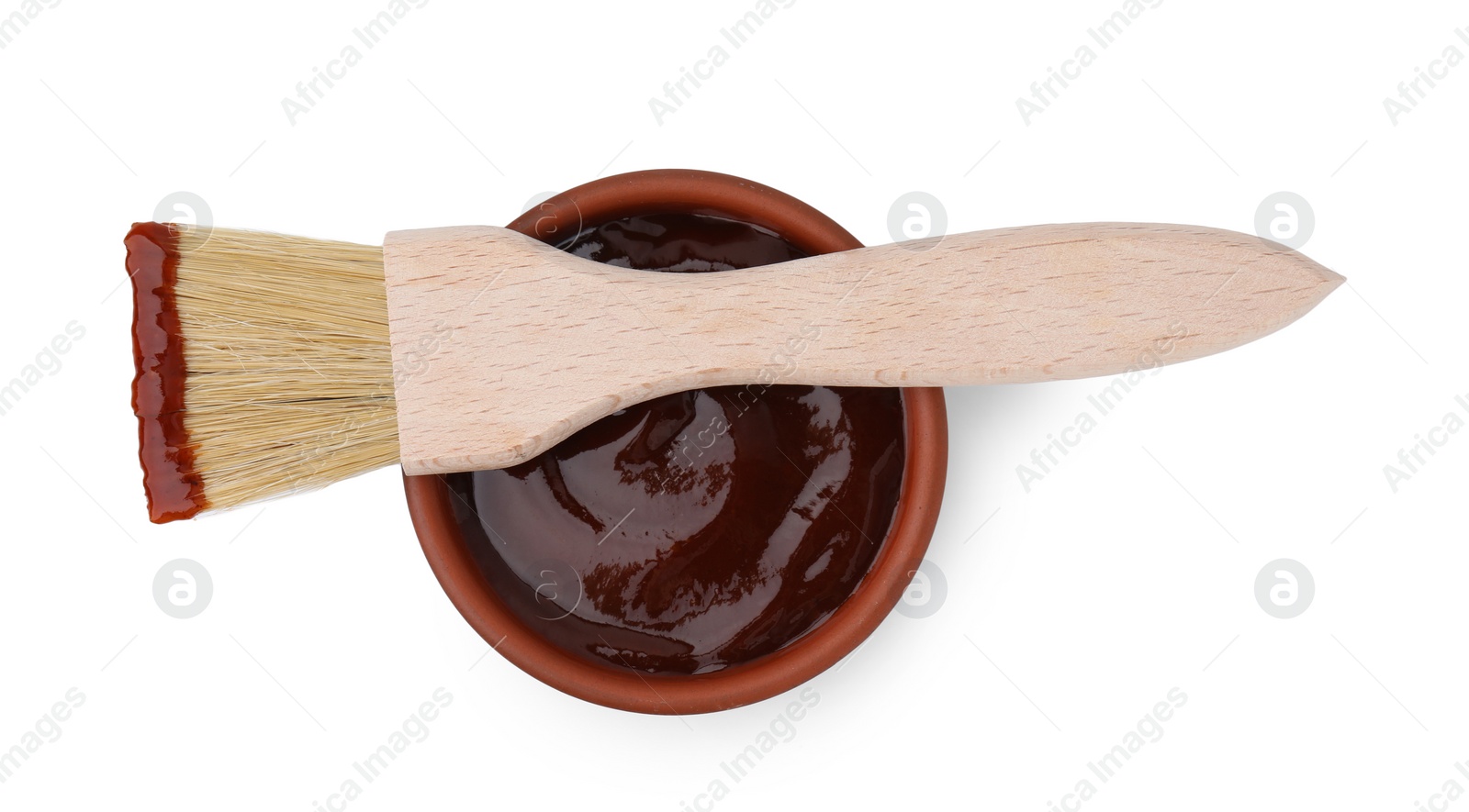 Photo of Marinade in bowl and basting brush isolated on white, top view