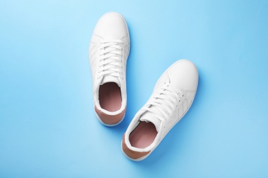 Photo of Pair of sneakers on color background, flat lay