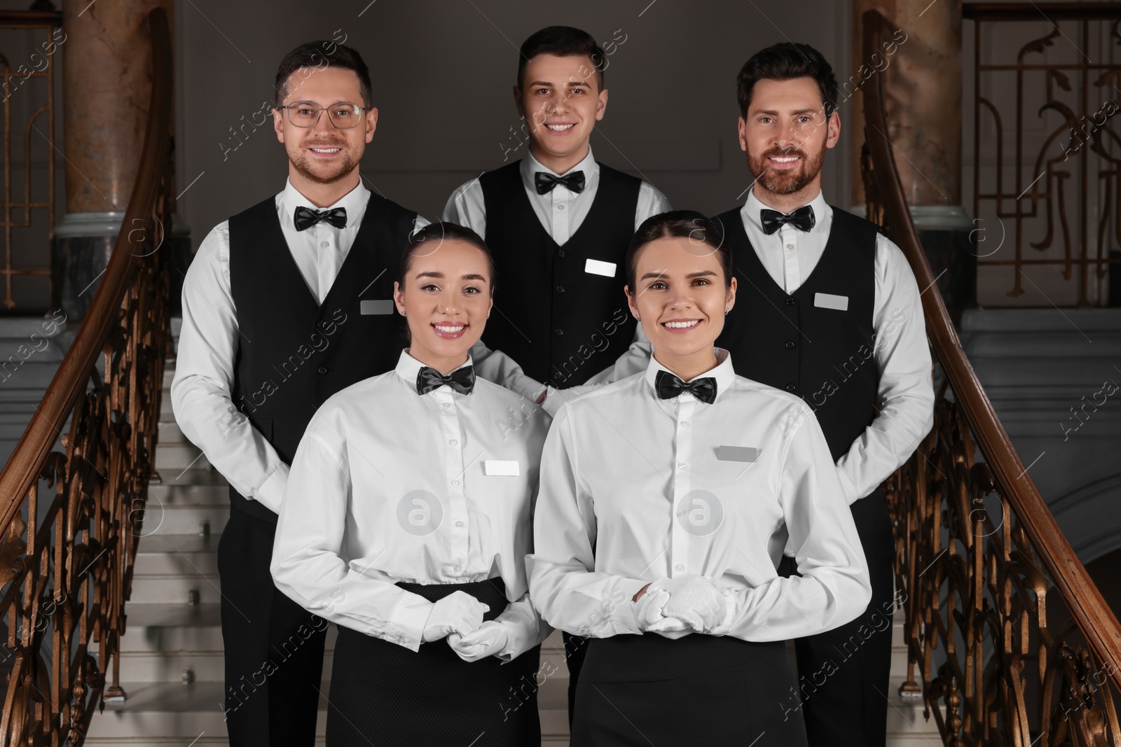 Photo of Group of trainees wearing formal clothes in hotel. Professional butler courses