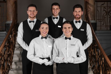 Photo of Group of trainees wearing formal clothes in hotel. Professional butler courses