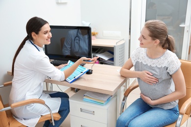 Photo of Pregnant woman having appointment at gynecologist office