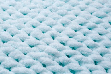 Soft light blue knitted fabric as background, closeup