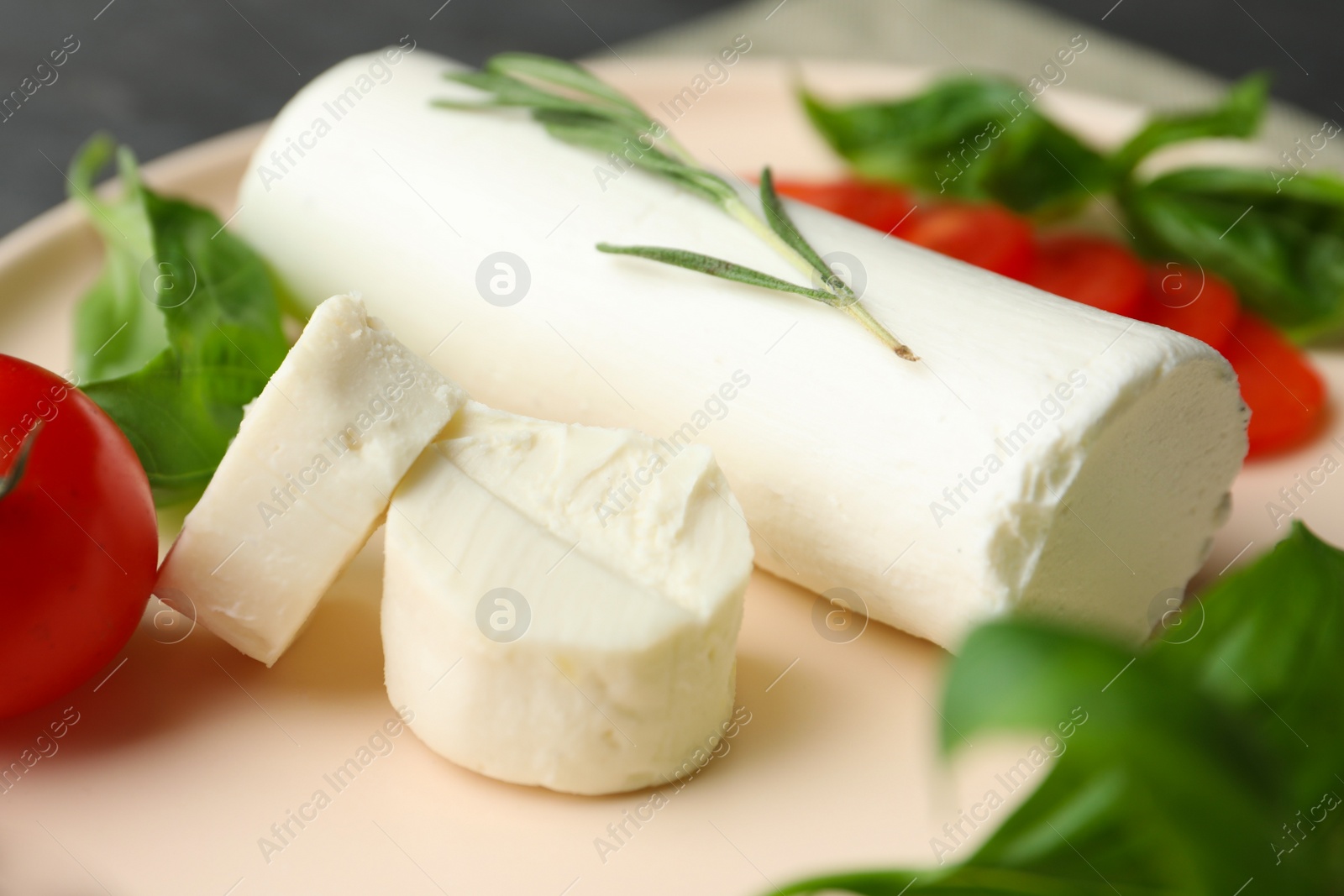 Photo of Delicious goat cheese with rosemary on plate, closeup