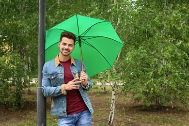 Man with umbrella outdoors on rainy day