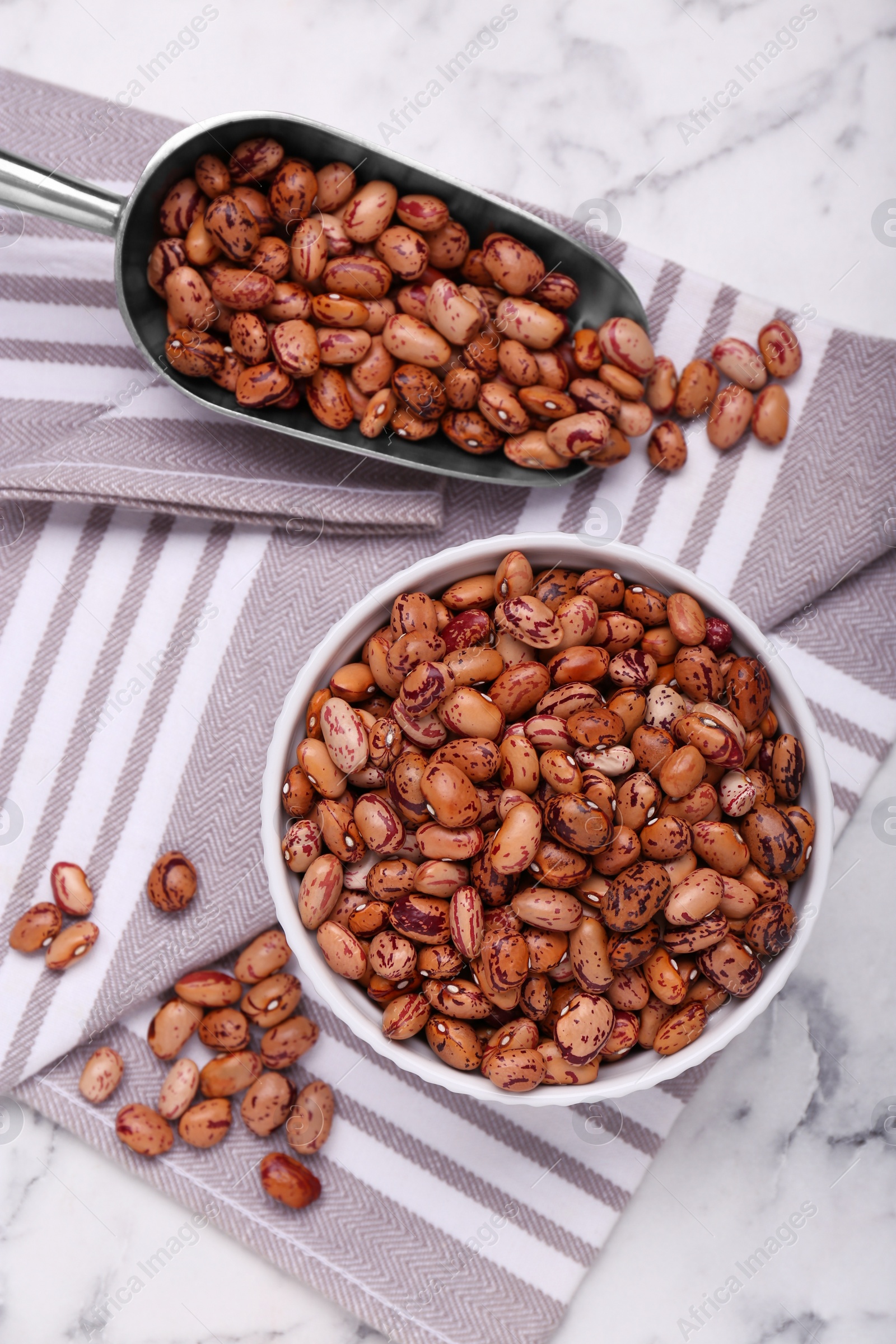 Photo of Many dry kidney beans on white marble table, flat lay