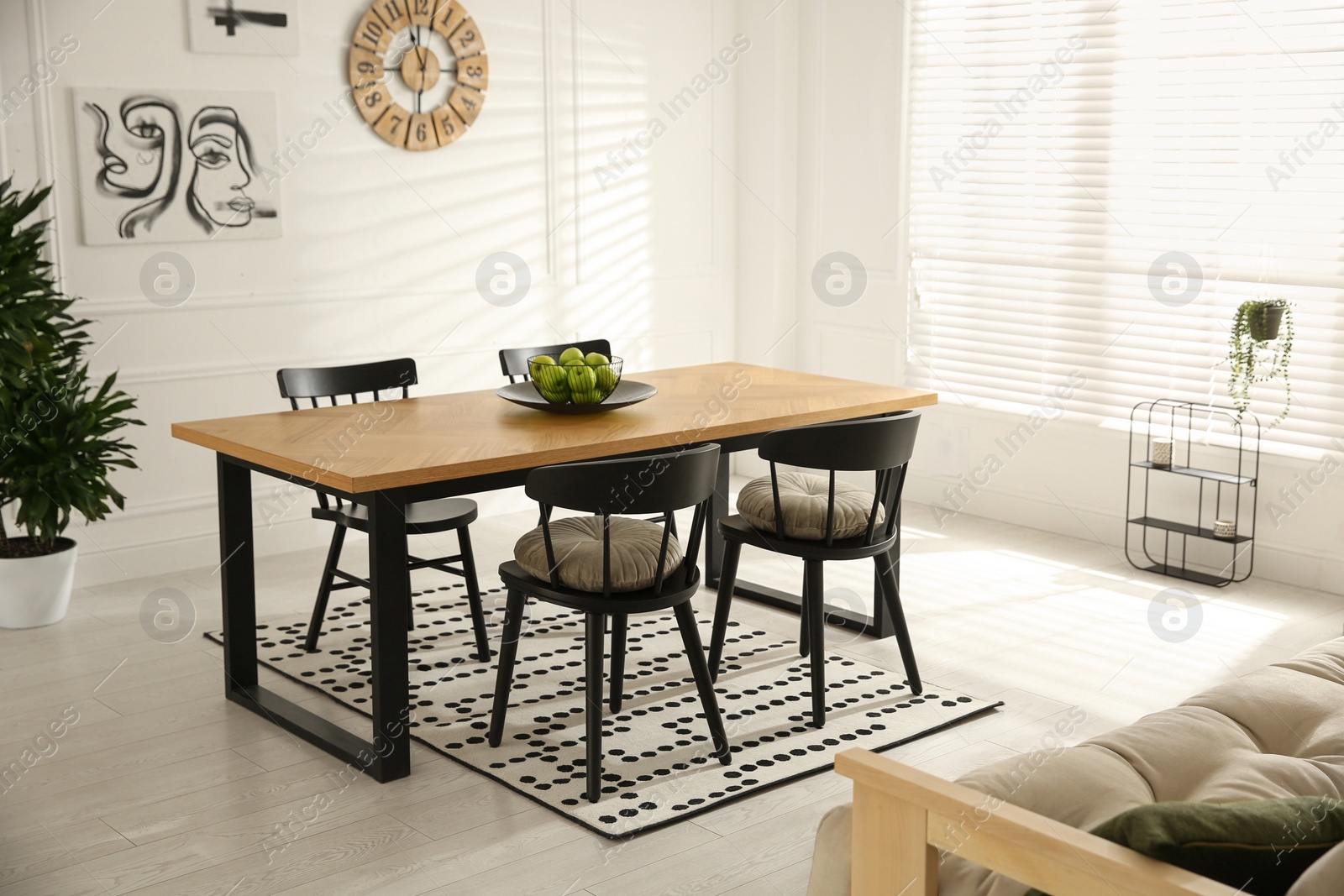 Photo of Stylish wooden dining table and chairs in room. Interior design