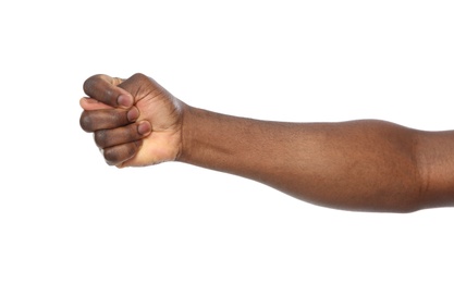 Photo of African-American man showing fig gesture on white background, closeup