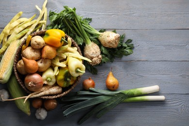 Photo of Different fresh ripe vegetables and fruits on grey wooden table, flat lay. Space for text