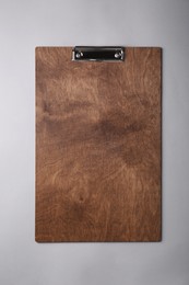 Wooden clipboard on light grey background, top view