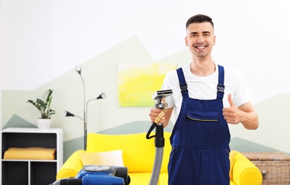 Photo of Dry cleaning worker with professional apparatus indoors